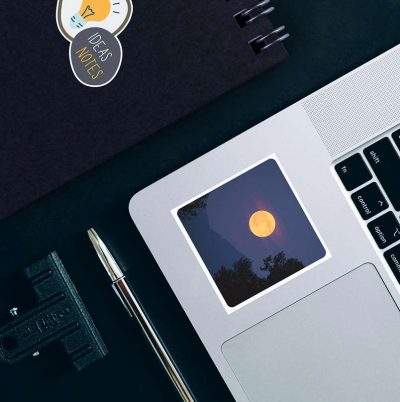 Moon and space stickers on laptop.
